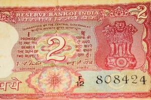 Old Two Rupee notes combined on the table, India money on the rotating table. Old Indian Currency notes on a rotating table, Indian Currency on the table photo