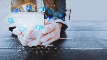 Concept with notification icons of social media on smart phone. Woman's hands holding her phone with notification icons of love, like, message, chat, comment and shopping above smartphone screen. photo