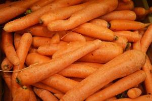 Fresh orange carrots on the store counter. Background. Vegetables, harvest. photo