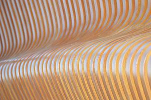 Sunlight and shadows on the surface of vertical wooden slats. Wooden boards that change angle. Abstract wooden background. photo
