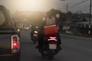 Abstract and blurred of rear side of pickup car open tail light of brake car. Driving on the road with other motorsidcle in the evening. photo