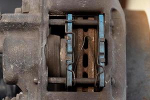 Close-up view of the inside of a caliper with used of breaker pads. car maintenance background. photo