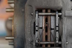 Close-up view of the inside of a caliper with new of breaker pads. car maintenance background. photo