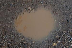 The hole in the flooded road is similar in shape to the heart. for background and textured. photo