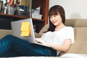 College student study online stay at home via internet in living room photo