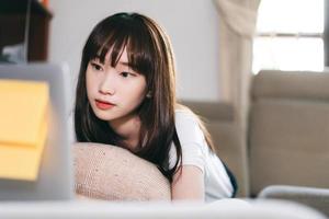 Asian teenager woman work and study online via internet at home. photo