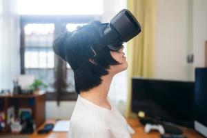 Woman wear VR headset for modern technology lifestyle. Focus on helmet. photo