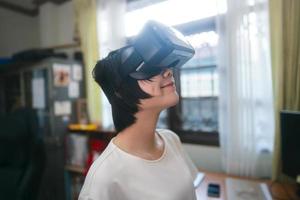 Young adult asian woman wear VR headset for modern technology lifestyle. photo