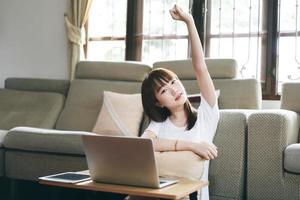 Young asian woman teenager stretching arms at home photo