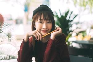 Portrait of young cute asian teenager student woman wear red sweater. photo