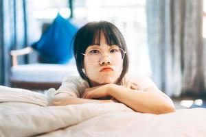 Portrait young adult asian woman relax in bedroom after wake up stay at home with eye attractive. photo