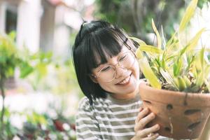 Young adult asian woman lifestyle at home garden on summer day. photo