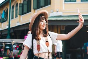 Young adult asian woman outdoor travel in city on summer photo