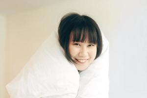 Portrait young adult asian woman relax in bedroom after wake up stay at home with eye attractive. photo