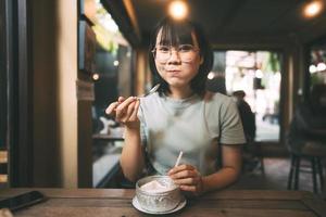 Happy face young adult asian woman eating coconut juice. photo