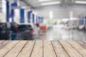 Wood table top with blur garage background photo