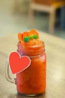 Strawberry smoothie with fresh berries on wood table photo