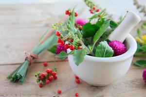 Fresh herbs in the mortar, alternative medicine photo