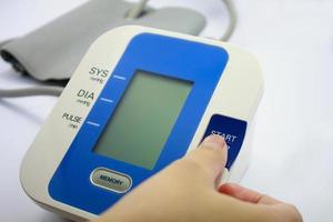 Digital Blood Pressure Monitor on white background photo