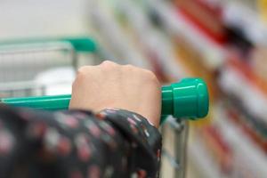 Closeup woman shopping in supermarket photo