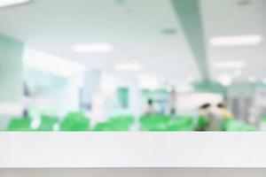 Empty white desk with blur hospital background photo