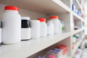 medicine bottles arranged on shelf at drugstore photo