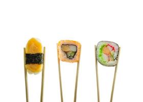Sushi in chopsticks isolated on white background photo