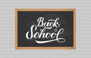 Chalkboard with wood frame on brick wall of classroom. Back to school calligraphy hand lettering. Vector template for typography poster, logo design, banner, flyer, greeting card, sign, invitation.