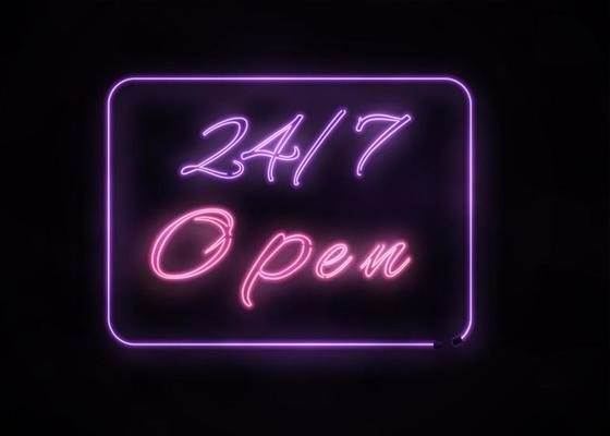 Neon Open 24 7 sign on black background.