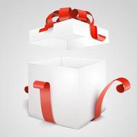 Open gift box with red bow isolated on white.