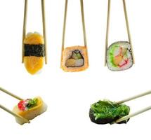 Sushi in chopsticks isolated on white background photo