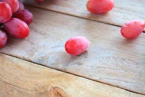 red grapes on wooden background photo