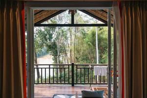 Tropical rainforest and river view from wooden balcony of the resort on vacation photo