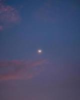 Crescent moon glowing in the sky photo