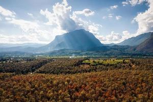 Aerial view of Doi Luang Chiang Dao mountain with autumn colorful forest in national park on bright day photo