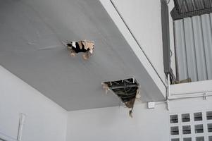 Ceiling panel damaged and crack hole with wire system from water leakage photo