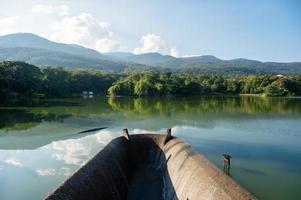 Ang Kaew reservoir with mountain range and blue sky on sunny day photo