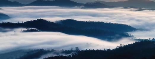 Foggy flowing on mountain range in the valley at countryside