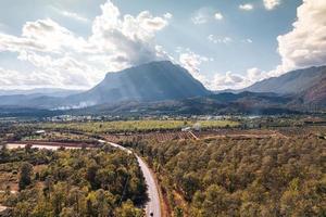 Aerial view of Doi Luang Chiang Dao mountain with the road among the autumn forest on bright day at Chiang Dao photo
