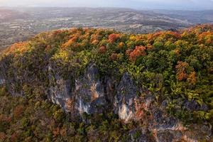 Aerial view of autumn forest on limestone mountain photo