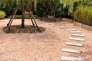 Zen stone path on gravel floor in the garden photo