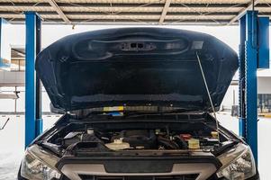 Pickup truck with car hood opening for maintenance the engine in the garage photo