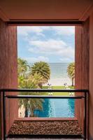 Frame of balcony structure with sea view, swimming pool and garden photo