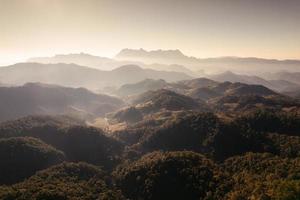 Scenery of Doi Luang Chiang Dao with stacked mountain layer and foggy on sunny day photo