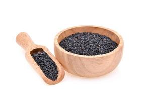 Black sesame in a wooden cup isolated on white background photo