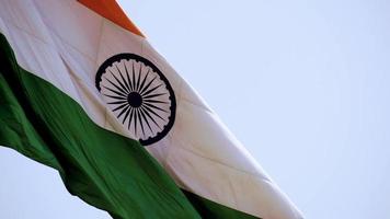 bandeira da índia voando alto com orgulho no céu azul, bandeira da índia tremulando, bandeira indiana no dia da independência e dia da república da índia, inclinar o tiro, acenando a bandeira indiana, hasteando bandeiras da índia video