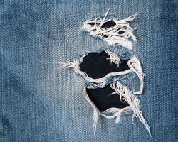 Jeans texutre with a hole photo