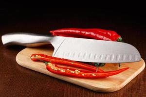 Chili pepper and knife photo