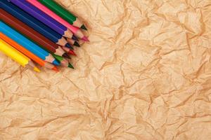 Multicolored pencils and crumpled paper photo