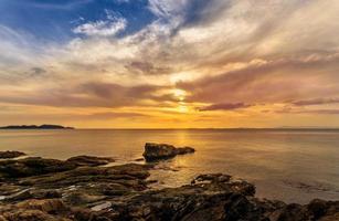 Landscape of beautiful seascape. Sea, rock and cloud in the sky at the sunset. photo